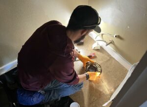 plumber replacing wax ring on toilet drain.