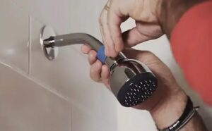 plumber replacing shower head