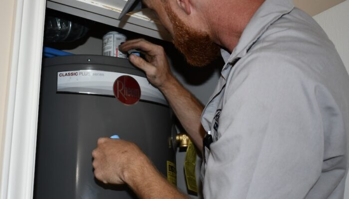 plumber performing water heater repair and maintenance