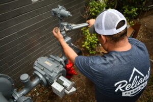 A commercial plumber fixing a gas line.