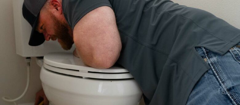 plumber fixing a toilet leak