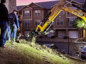 plumbers, excavator at a multifamily residential building